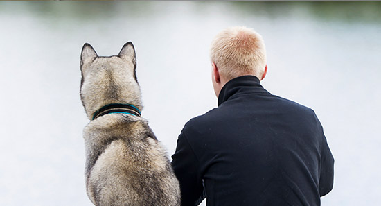 A man sitting with his dog
