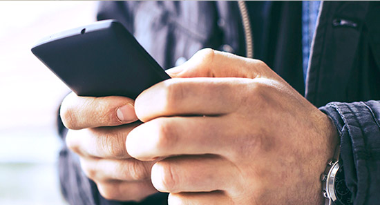 A man using a smartphone to donate