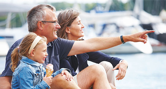 Man smiling with his wife and child